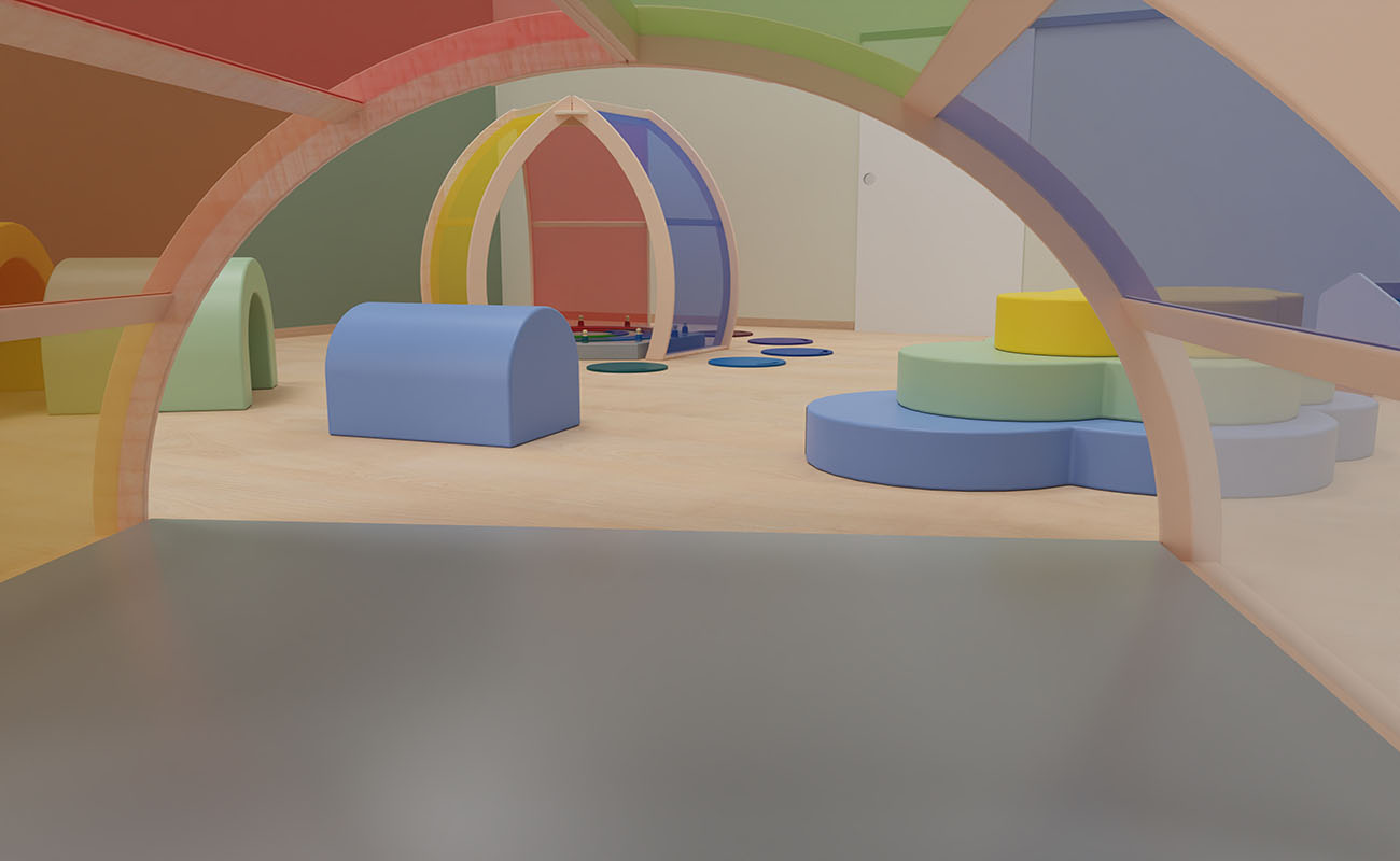 Gruppenraum Regenbogen Ausschnitt mit Sicht aus dem EduCasa Acrylglas Regenbogen und Blick auf  Farbtempel, Softelemente und Kriechtunnel