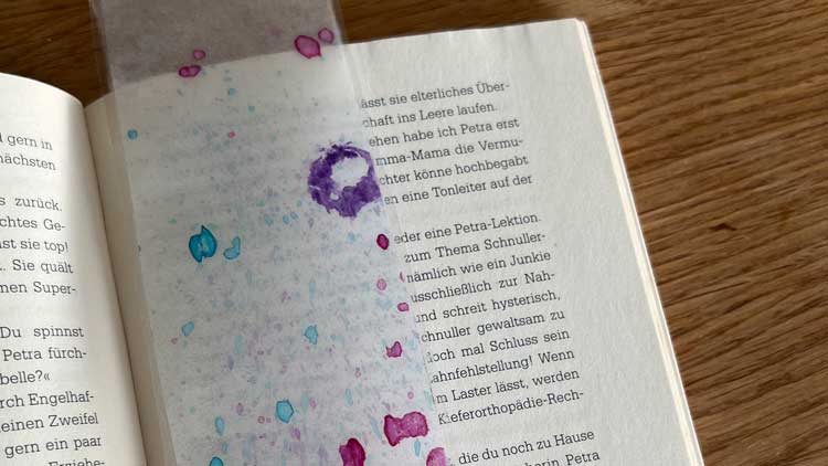 Mit Transparentpapier, Wasserfarbe und einer Zahnbürste entstehen  gesprenkelte Kunstwerke.