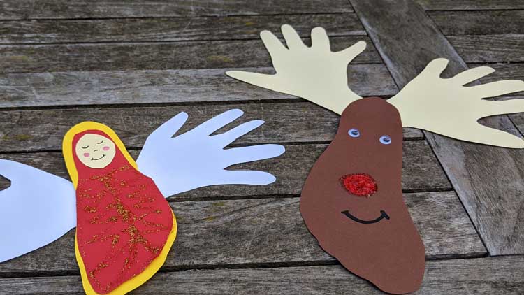 Rentier und Engel aus Hand- und Fussumrissen auf Tonpapier gebastelt - eine tolle Geschenkidee aus dem Betzold Blog.