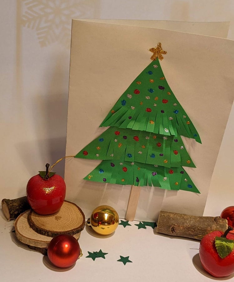 Weihnachtskarte mit Tannenbaum aus Papier, verziert mit Glitzerkleber aus dem Betzold Shop.