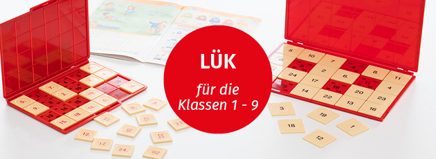 Zwei unterschiedliche grosse LÜK-Kontrollgeräte in rot auf einem weissen Tisch